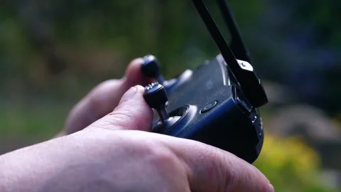 Hands with drone and remote controller in background Stock Footage 316818272