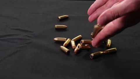 Hands drop a handful of cartridges Stock Footage 281105782