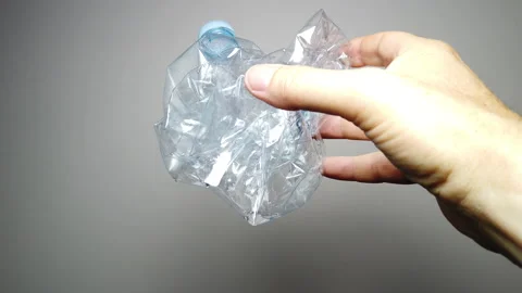 Hands dropping a plastic bottle Stock Footage 135827222