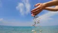 The hands dropping the stones in the sea. slow motion HD Footage