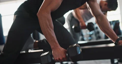 Hands, dumbbell and personal trainer with people in gym for training, exercise Stock Footage 290059956