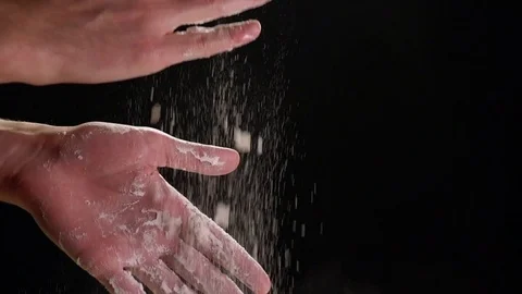 Hands Dusting and Clapping Flour on Black Background in Slow Motion Stock Footage 82149284
