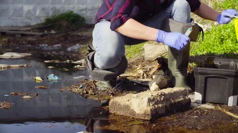 Hands of ecologist taking samples of the water. Stock Footage 90180473