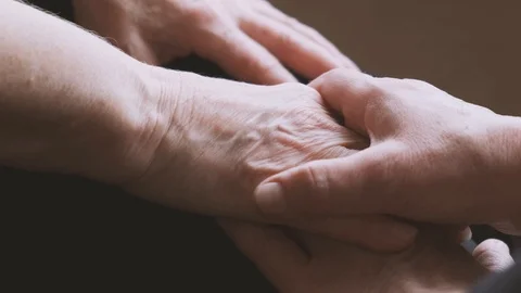 Hands of an elderly husband stroking the wrinkled hand of an old woman's wife Stock-Footage 120014389