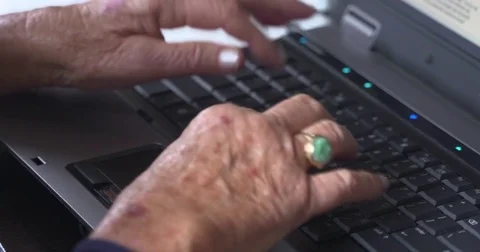 Hands of an elderly lady typing on laptop keyboard Stock Footage 81822850