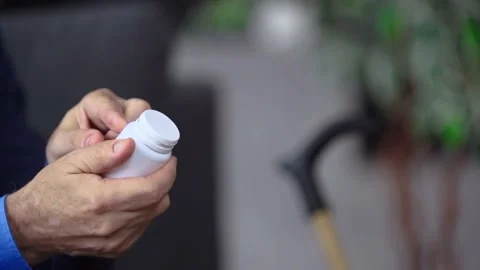 Hands of an elderly man are holding medicine read prescription Stock Footage 235945402