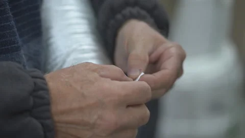 Hands of an elderly man checking a rope Stock Footage 295143355