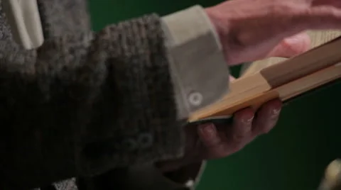 Hands of an elderly man flipping book Stock Footage 53269071
