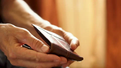 Hands of an elderly man holding an empty wallet Stock Footage 245967707