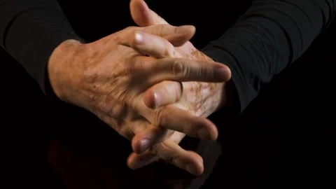 Hands of an elderly man isolated on black background. Stock Footage 130348700