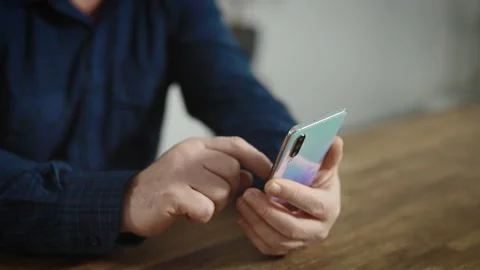 Hands of an elderly man with a smartphone. Retired, typing or watching the news Stock Footage 234869168