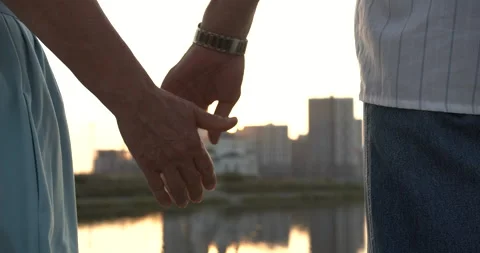 Hands of elderly people touch each other against the background of the city Stock Footage 135555787