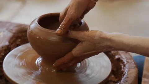 Hands of an elderly potter working with clay on a potter's wheel 스톡 동영상 156025802