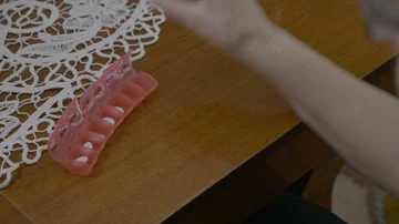 Hands of an elderly woman preparing her medications for the next week using a Stock Footage 85527151