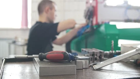 Hands of electrician engineer screwing and testing equipment in fuse box, de Stock Footage 90668807