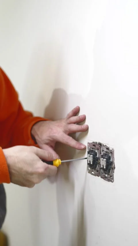 Hands of Electrician Fixing Electrical Outlet, Close-Up of Professional Work Stock Footage 332143024