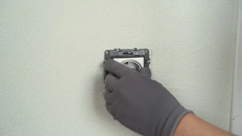 Hands of electrician install electrical socket. Replacing electrical outlet Stock Footage 279075711