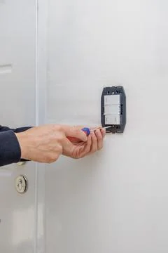 Hands of an electrician installing an electrical switch. 写真素材