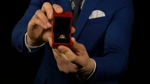 Hands of elegant man holding and presenting jewelry box with ring inside Stock Footage 74678366
