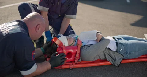 Hands, emergency first aid and a paramedic team with a patient or victim on the Stock Footage 252641414