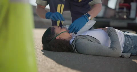 Hands, emergency or oxygen and a paramedic with a woman patient or victim on the 動画素材 252650865