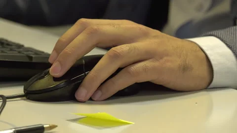 Hands of an employee move the mouse on the desk Stock Footage 303275973