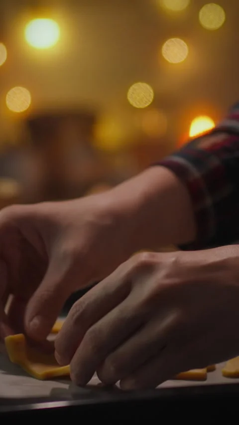 Hands engaged in a focused task at a cozy venue during evening hours Stock Footage 331597083