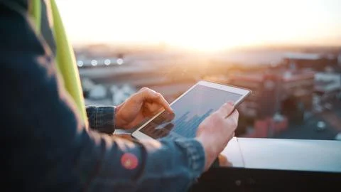 Hands, engineer and graphs with tablet screen for construction, budget and .. Foto stock