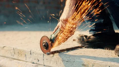 Hands, engineer and grinder with rod at construction site for welding, cutting 写真素材