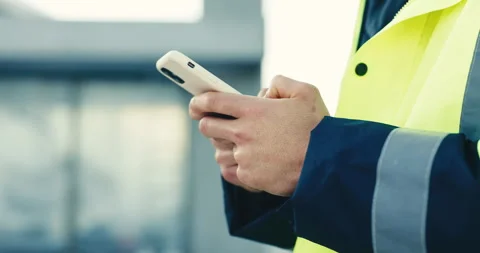 Hands, engineer and typing on phone for communication, construction or building Stock Footage 345572533