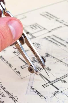 Hands of an engineer with construction plans Stock Photos