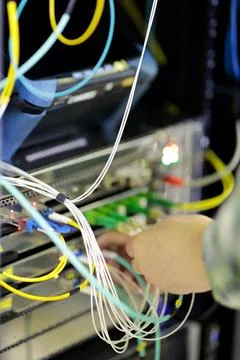 Hands of engineer plug in fiber optic cables Stock Photos