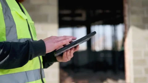 Hands of engineer using touchscreen on digital tablet checking blueprints Stock Footage 274481341