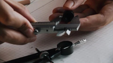 Hands of Engineer using vernier caliper to scale the black screw Stock Footage 170410761