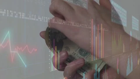Hands entering frame, flipping and fanning US bills while charts shifting to Stock Footage 329453436