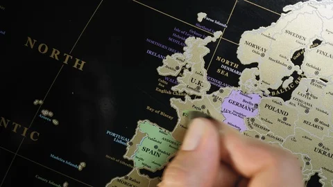 Hands erase country on the scratch map with metal plate Stock Footage 103301294