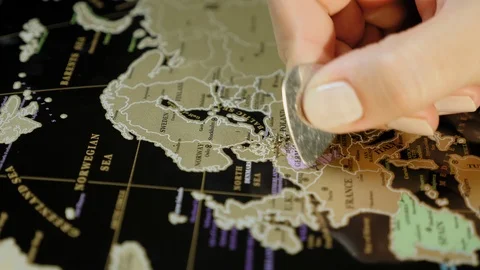 Hands erase country on the scratch map with metal plate Stock Footage 103315280