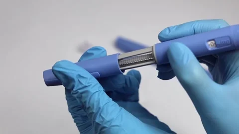 Hands in examination gloves demonstrate an injection with insulin for diabetics. Stock Footage 263144117