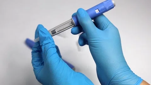 Hands in examination gloves demonstrate an injection with insulin for diabetics. Stock Footage 263144217