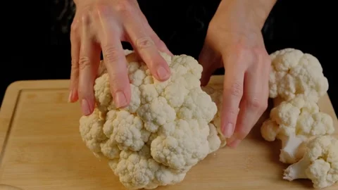Hands Examining Cauliflower on Cutting Board in Cooking Studio Stock Footage 341446683