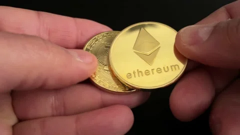 Hands exchanging two types of virtual currencies Stock Footage 169643064