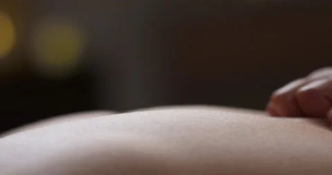 Hands of experienced masseur touching back of female body. Gentle procedure of Stock-Footage 180663327