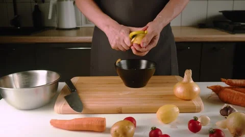 Hands expertly squeeze a lemon into a bowl while surrounded by colorful Stock Footage 316629042