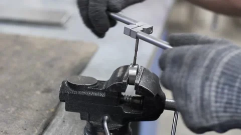 Hands of a factory worker in gray gloves make thread in a metal part Stock Footage 134198724