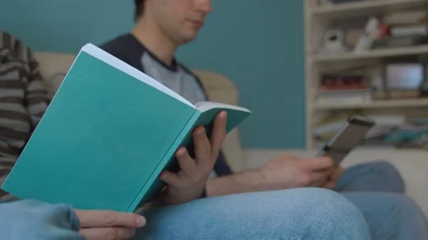 Hands of family reading on the couch Stock Footage 130963331
