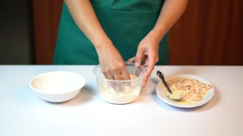 Hands of Female Chef Coating Raw Prawns with Flour in a Plastic Bowl 스톡 동영상 334322372