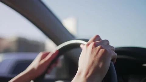 Hands of the female driver on the steering wheel of the car. Traffic control in Stock-Footage 183365671