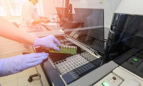 Hands of a female laboratory assistant loading a sample Stock Photos