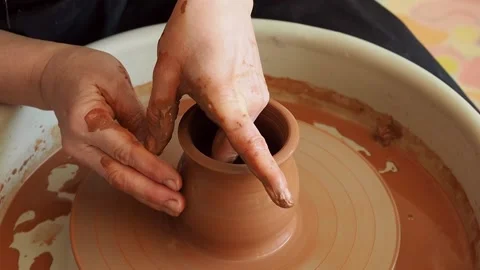 Hands of a female master potter form a clay pot  Stock Footage 235758775