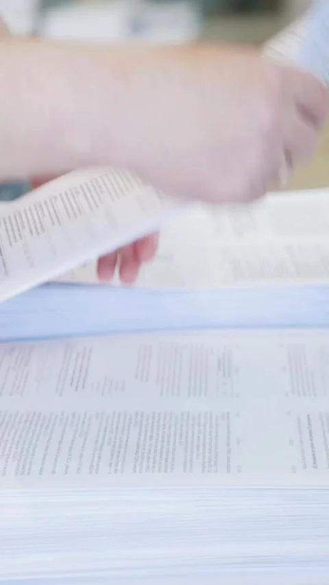 Hands of female worker sorting newspapers and puts on in stacks in the Stock Footage 346707168
